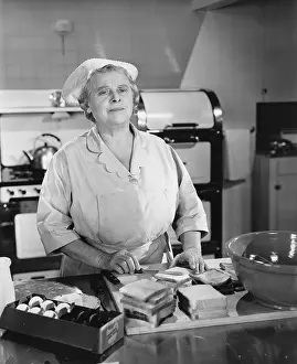 Daydreaming: Woman cook at the cafeteria kitchen