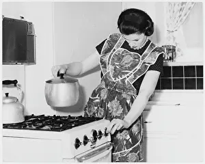 Stove: WOMAN COOKING 1960S