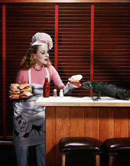 Hamburgers: Woman Cooking With Her Iguana