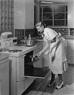 Camerique: Woman cooking in her kitchen