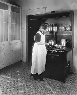Perplexed: Woman cooking in kitchen