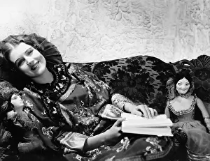 Indulge: Woman on couch with dolls