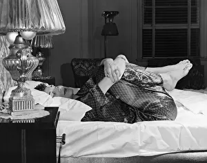 Fetal: Woman curling up on a bed