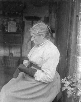 Darns: WOMAN DARNING STOCKINGS