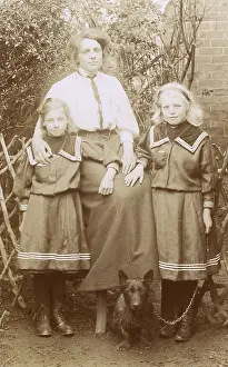 Daugther: Woman with her two daughters and a Scottish Terrier