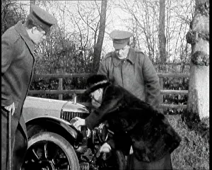 Crank: A Woman Demonstrating How To Start A Motorcar