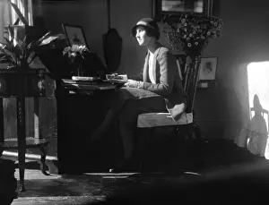 Thoughtful: Woman at a desk in Rome