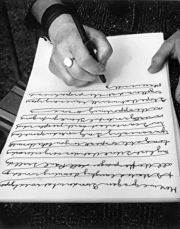 Continuous: Woman doing automatic writing in a garden