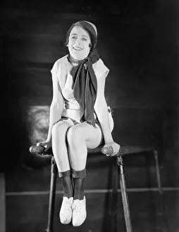 Toothy: Woman doing gymnastics on parallel bars