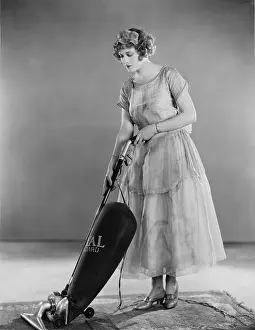 Sweepers: Woman doing housework with a vacuum cleaner