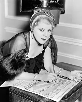 Puzzles: Woman doing puzzle in newspaper