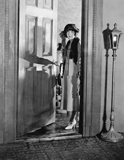 Anticipating: Woman dressed up standing in the doorway