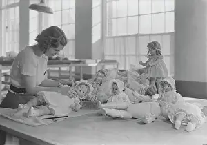 Packing: Woman dressing and packing dolls, 1936