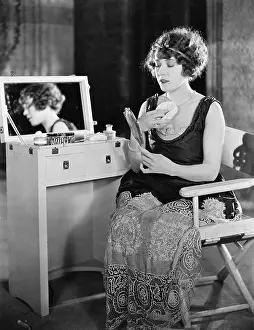 Powdering: Woman at dressing table