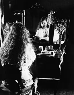 Brood: Woman at dressing table looking in mirror