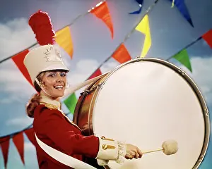 Banging: Woman Drum Majorette Beating Large Base Drum