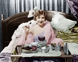 Indulge: Woman eating breakfast in bed