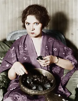 Frustrations: Woman eating chocolates out of a bowl