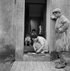 Stooping: Woman feeding a kitten