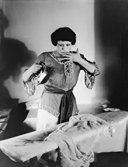 20 25: Woman with a finger in her mouth after she burned