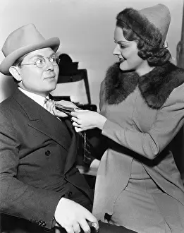 Interactions: Woman fixing mans tie