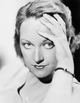 Intensely: Woman with hand on her head intensely staring