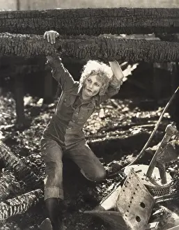 Jumpsuit: Woman hanging on to fallen logs