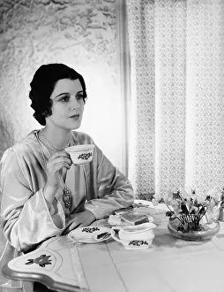 Teacup: Woman having meal at table