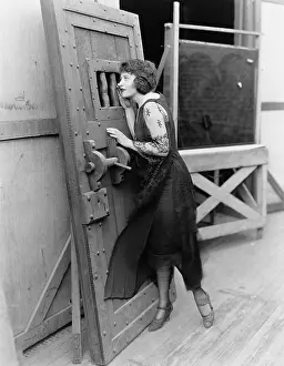 Cautious: Woman with heavy door