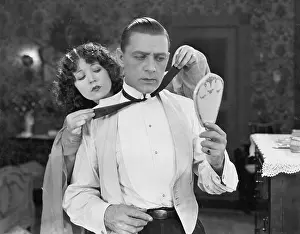 Apprehension: Woman helping man tie bow tie