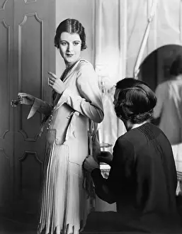 Aiding: One woman helping another woman getting dressed