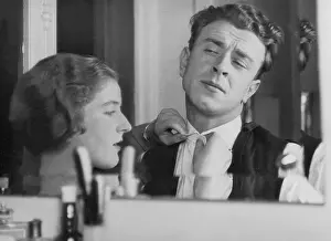 Fasten: Woman helps man to fasten collar button