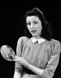 Dismayed: Woman Holding Broken Mirror