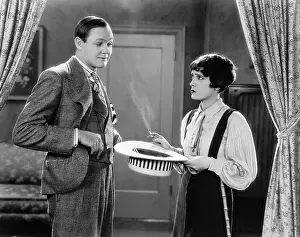 Skeptic: Woman holding hat and smoking interacting with man