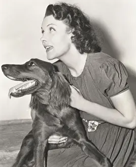 Obedient: A woman holding her Irish setter