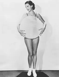 Leggy: Woman holding a large circle in front of her torso