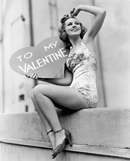 Thoughtfulness: Woman holding a large valentine