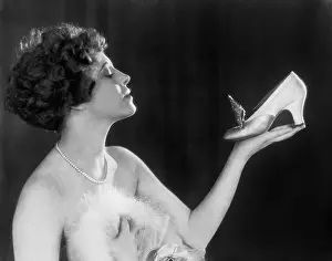 Emotional: Woman holding shoe