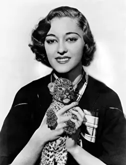 Tenderness: Woman holding tiny leopard cub