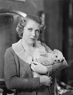 Tenderness: Woman holding tiny puppy