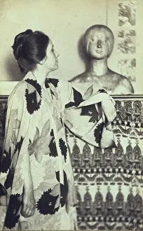 Schutze: Woman in a kimono standing looking at a ?