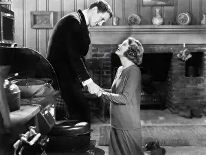 Imploring: Woman kneeling to a man
