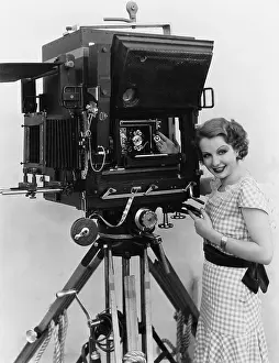 Uncertainty: Woman with large camera