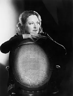 Backrest: Woman leaning over the back of a chair