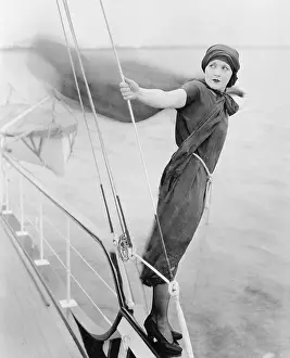 Precarious: Woman leaning off boat into the wind