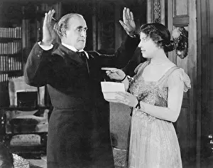Marital: Woman with a letter in her hand pointing at a man