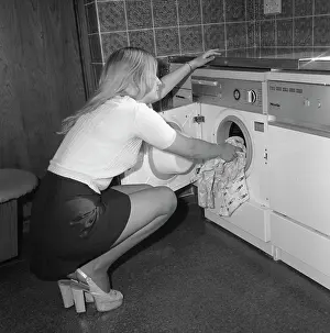 Slingback: Woman loading a washing machine