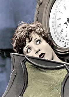 Quizzical: Woman looking up at a clock or weighing machine