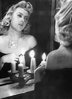 Wardrobe: Woman looking at herself in the mirror, 1941