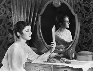 Vanities: Woman looking in mirror